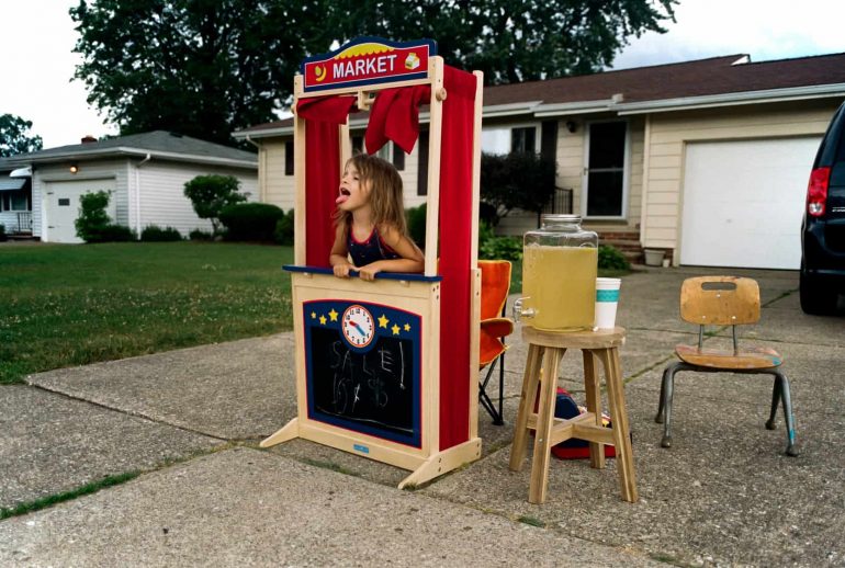 little girl has lemonade stand